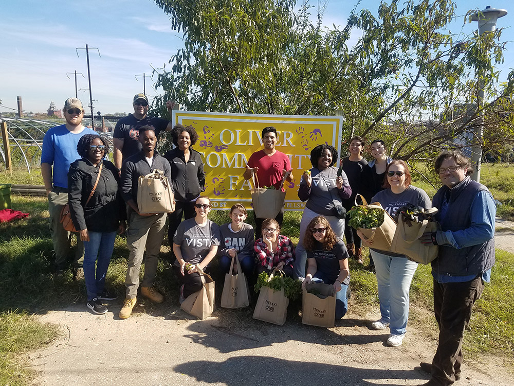 vista members holding bags of produce outside of a farm