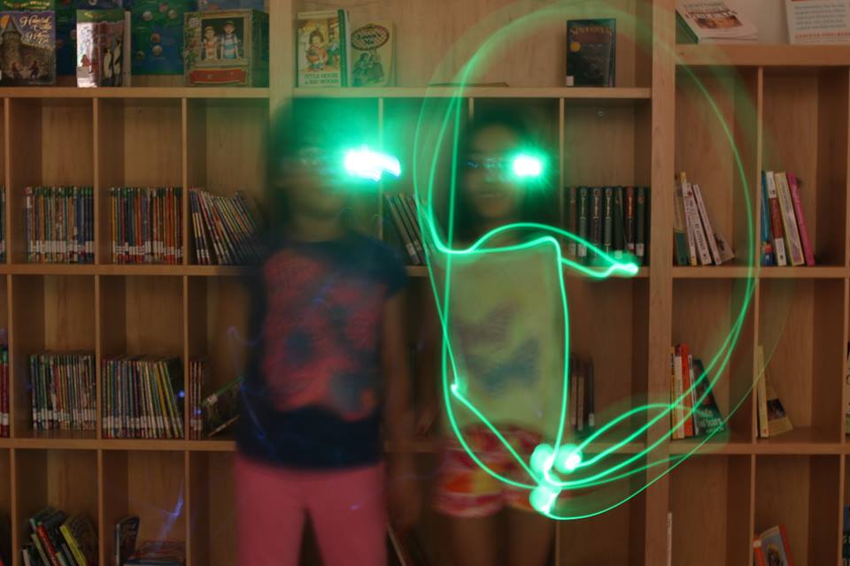 children making shapes with glowing lights