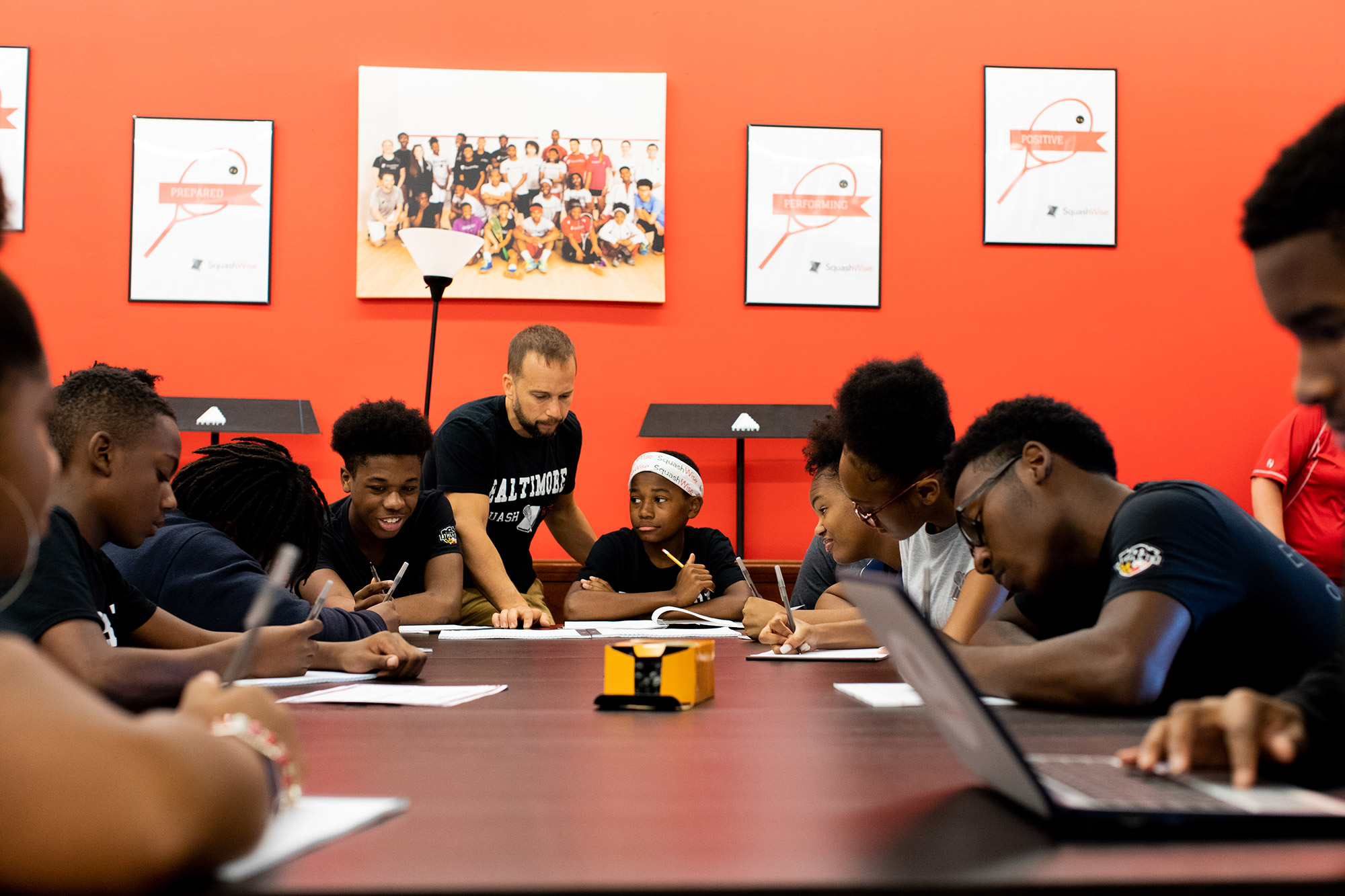 students sitting around conference table writing